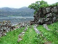 
(20c) The preaching wall and seats at Am-ploc, at the head of the Loch.  It is thought to have once been a Viking meeting place.
	